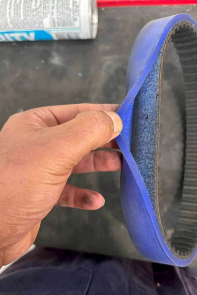 failed 60 shore a t10 silicone coated timing belt showing coating delamination from rubber base